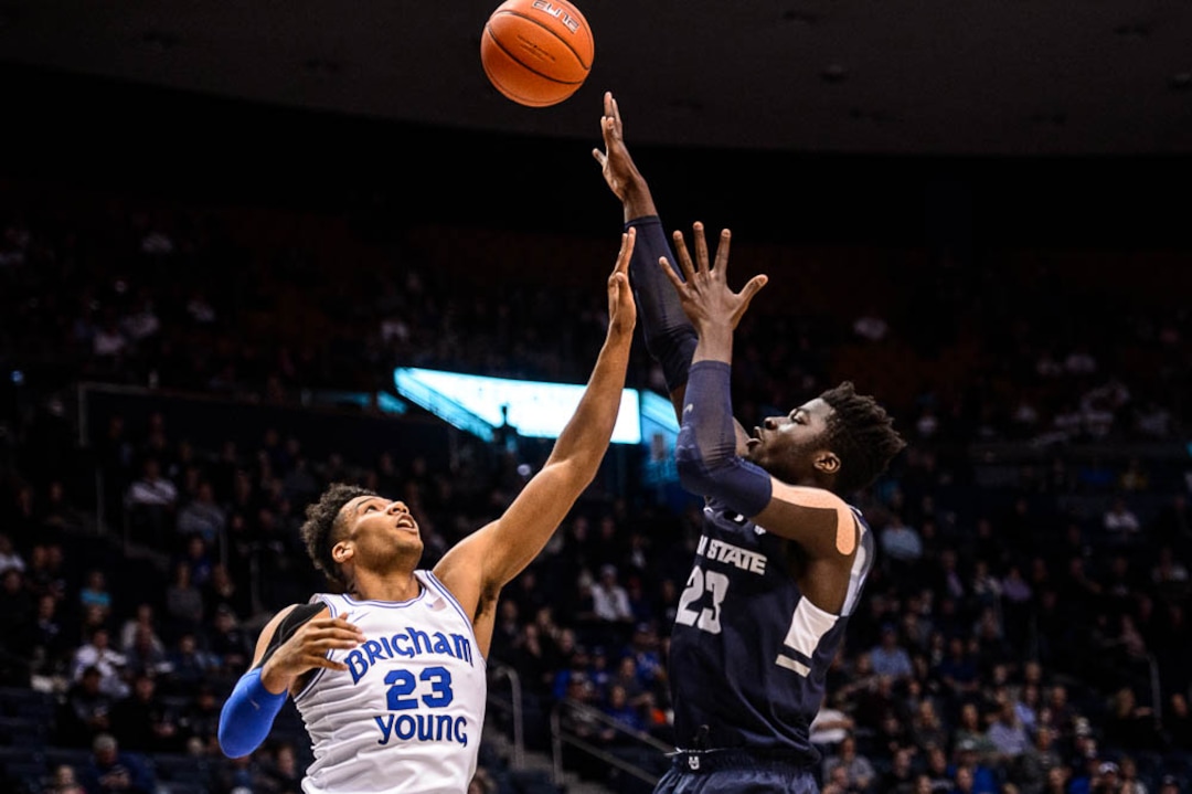(Trent Nelson | The Salt Lake Tribune)  Utah State Aggies center Neemias Queta (23) shoots over Brigham Young Cougars forward Yoeli Childs (23) as BYU hosts Utah State, NCAA basketball in Provo on Wednesday Dec. 5, 2018.