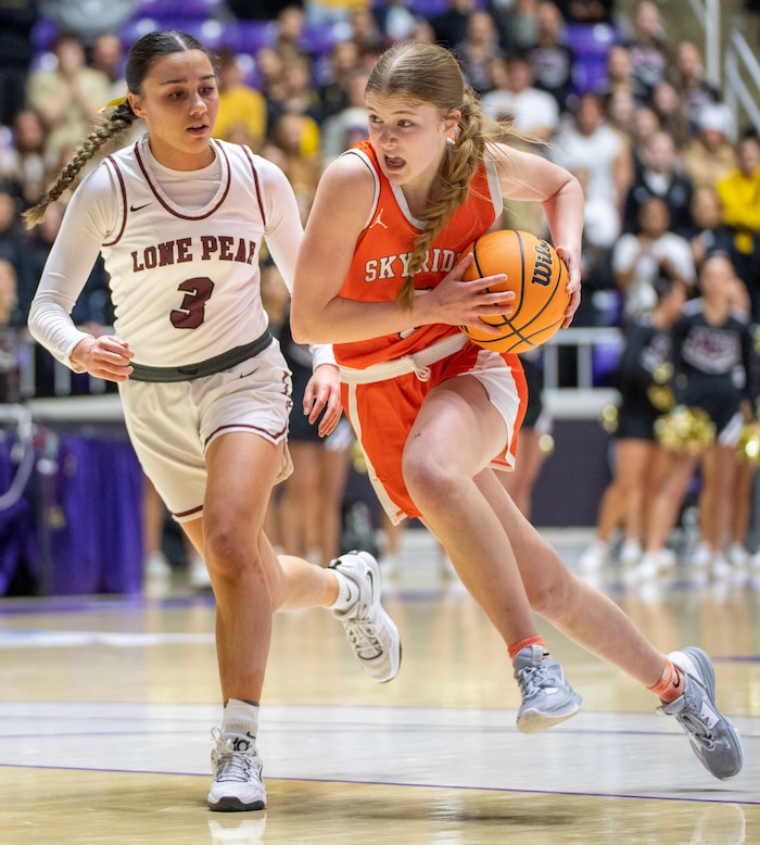 (Rick Egan | The Salt Lake Tribune) Cambree Blackham (5) takes the ball inside as Lone Peak guard Shawnee Nordstrom defends in the 6A girls Championship Game between Skyridge and Lone Peak, at Weber State, on Saturday, March 4, 2023.
