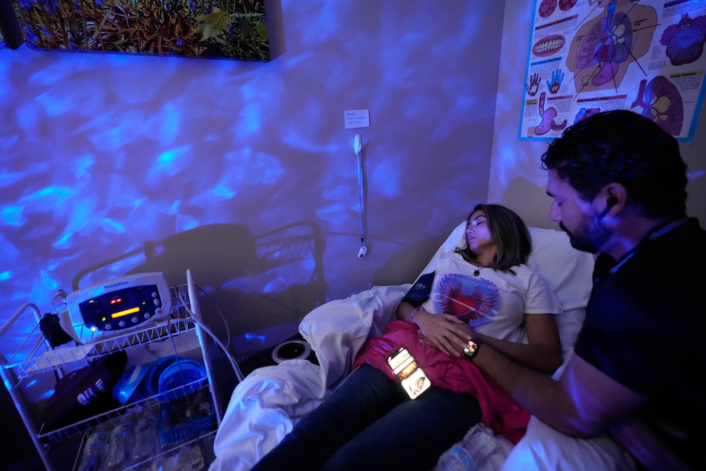 (Francisco Kjolseth | The Salt Lake Tribune) Christie Goodwin goes through a ketamine treatment as her fiancé Luis Zerr offers comfort at the Promise Medical Family Practice and Ketamine Clinic in Orem.