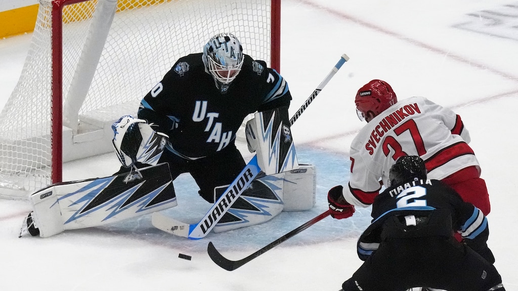 Utah Hockey Club goaltender Karel Vejmelka (70) makes a save against Carolina Hurricanes right wing Andrei Svechnikov (37) during the first period of an NHL hockey game Wednesday, Nov. 13, 2024, in Salt Lake City. (AP Photo/Rick Bowmer)