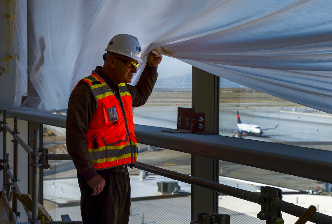 Leah Hogsten  |  The Salt Lake Tribune Leon Nelson, the Salt Lake City International Airport expansion project construction manager takes a peek at  the airport expansion construction site, Monday, Oct. 22, 2018. The first phase construction of the $3.6 billion project is due to open in 700 days. Nearing completion is the new concourse for aircraft gates, an enclosed terminal, the steel skeleton of a new "gateway" building, a five-story parking garage and elevated roadways. 
