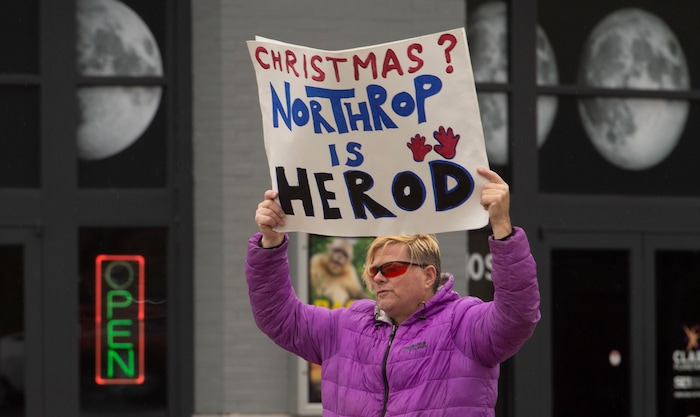 (Rick Egan  |  The Salt Lake Tribune) Marcus Collonge holds a sign during a picketing party against Northrop Grumman, on 400 West and 100 South across from the Clark Planetarium in Salt Lake City, Sunday, Dec. 8, 2019.