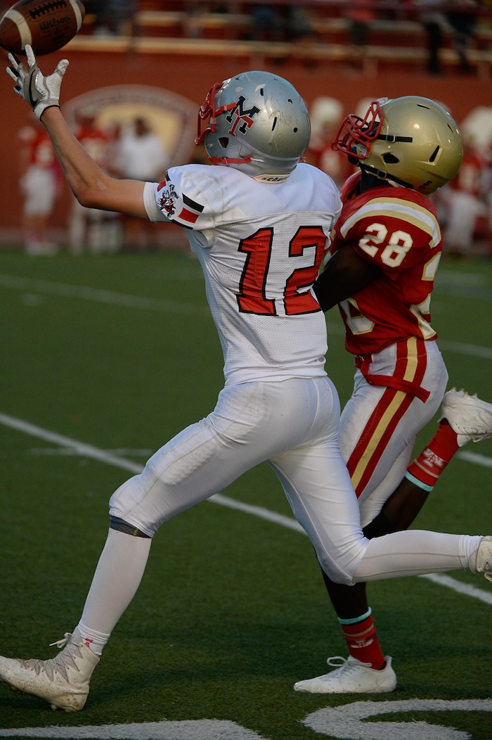 (Francisco Kjolseth  |  The Salt Lake Tribune)  Travis Thompson of Manti pulls in a long pass while pressured by  Fredrick Charles of Judge in the Class 3A football playoff game at Judge Memorial on Thursday, Oct. 19, 2017. 