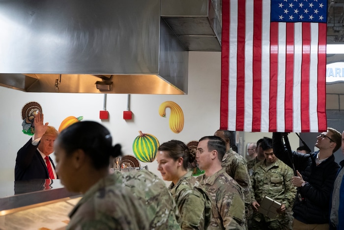 (Alex Brandon | AP) President Donald Trump, left, serves dinner during a surprise Thanksgiving Day visit to the troops, Thursday, Nov. 28, 2019, at Bagram Air Field, Afghanistan.