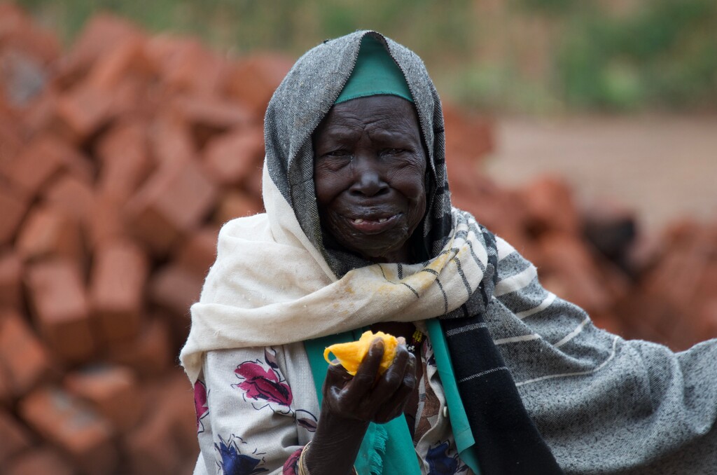 (George Papuashvili; Courtesy of The Church of Jesus Christ of Latter-day Saints)  A woman in the Bidi Bidi refugee settlement in Uganda enjoys a mango.