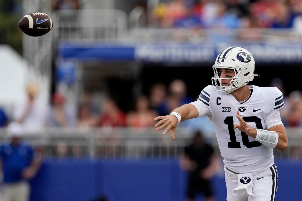 BYU quarterback Kedon Slovis passes the ball during the first half of an NCAA college football game against Kansas Saturday, Sept. 23, 2023, in Lawrence, Kan. (AP Photo/Charlie Riedel)