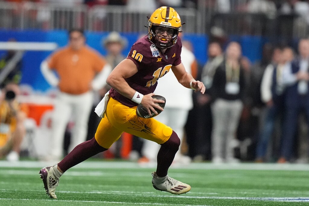 (Brynn Anderson | AP) Arizona State quarterback Sam Leavitt (10) runs out of the pocket against Texas during the first half in the quarterfinals of a College Football Playoff, Wednesday, Jan. 1, 2025, in Atlanta. 