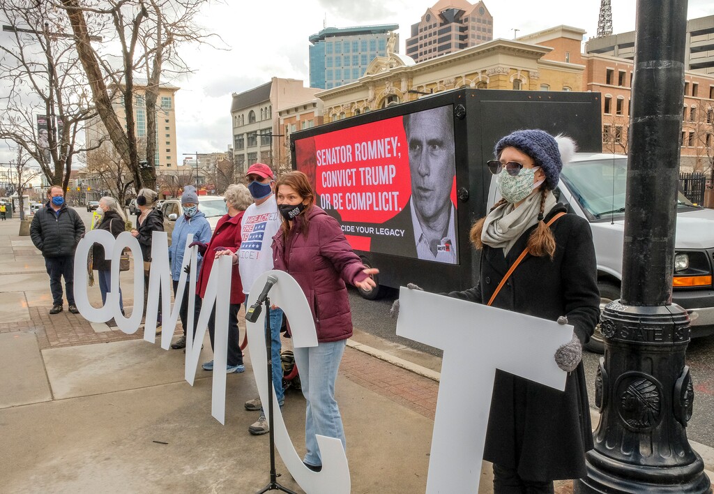 (Leah Hogsten | The Salt Lake Tribune) Members of Move-On staged a rally outside the Wallace F. Bennett Federal Building to encourage Sen. Mitt Romney to vote to impeach former President Donald Trump, Feb. 12, 2021. 
