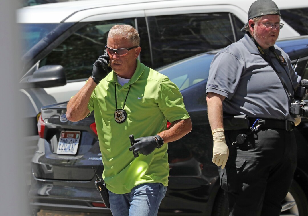 Police officers collect evidence in the parking lot of an apartment complex where Ayoola A. Ajayi was taken into custody in connection with missing University of Utah student Mackenzie Lueck Friday, June 28, 2019, in Salt Lake City.  Salt Lake City Police Chief Mike Brown said, Friday that Ajayi was being charged with aggravated murder, kidnapping and desecration of a body in the death of 23-year-old student. (AP Photo/Rick Bowmer)