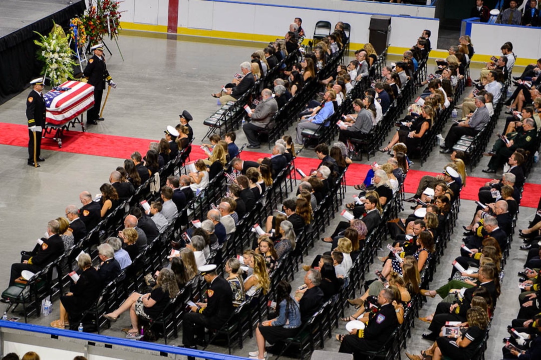 (Trent Nelson | The Salt Lake Tribune)  Funeral services for Battalion Chief Matthew Burchett at the Maverik Center in West Valley City, Monday Aug. 20, 2018.
