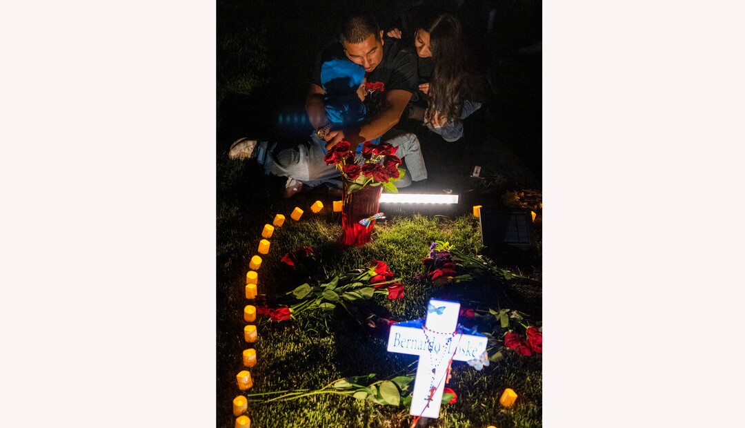 (Rick Egan | The Salt Lake Tribune) Bernardo's brother Freddie, holds his son Aieden, as he sits with his wife and  family and friends at Bernardo's grave in the Salt Lake City Cemetery, after the "Long Live Loske" gathering at Rose Park on Saturday, May 22, 2021. The family of Bernardo Palacios-Carbajal hosted a "1st Heavenly Anniversary" event to celebrate the life of their son and brother to mark the 1-year anniversary of his death on May 23, 2020 by Salt Lake City Police, who fired 34 shots, killing the 22-year-old man.