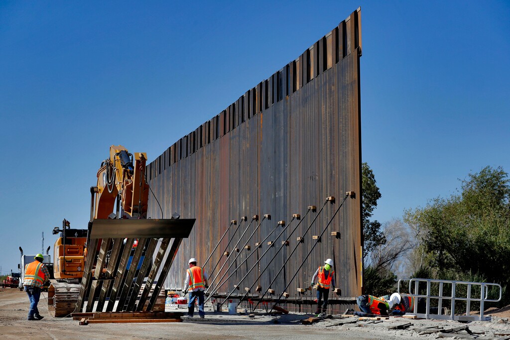 (Matt York | AP file photo) In this Sept. 10, 2019, file photo, government contractors erect a section of Pentagon-funded border wall along the Colorado River in Yuma, Ariz.  The Washington Post reports that once again President Donald Trump intends to divert money from the Pentagon to border wall construction.