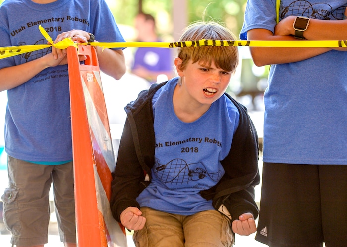 (Leah Hogsten | The Salt Lake Tribune) Centerville Elementary sixth grader Josh Longmore celebrates his robot's win during "Sumo" competition at the 2018 29th Annual Utah State University Physics Day. Over 9,000 high school and middle school students from Utah, Idaho, Wyoming and Nevada compete in science projects, Friday, May 18, 2018 at Lagoon Amusement Park in Farmington.