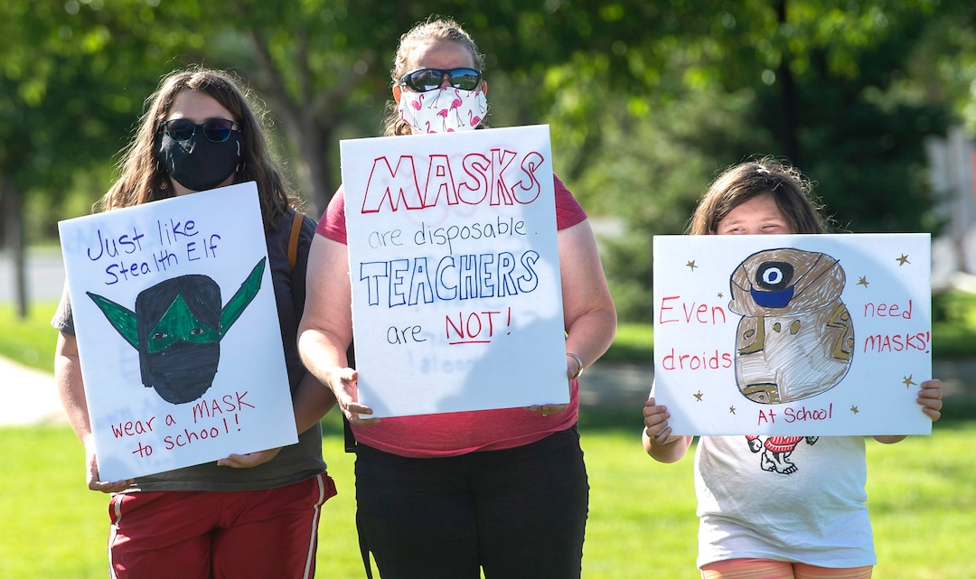 (Rick Egan  |  The Salt Lake Tribune)   Protesters hold signs, during the Mask-In and Car Caravan protest at the State Capitol to demand the Governor and other state and local leaders ensure that Utah school protect students and staff when schools reopen, on Thursday, July 23, 2020.