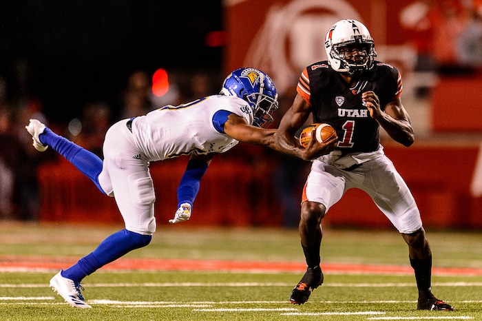 (Trent Nelson | The Salt Lake Tribune) Utah Utes quarterback Tyler Huntley (1) avoids San Jose State Spartans safety Maurice McKnight (10) as the Utah Utes host the San Jose State Spartans, NCAA football at Rice-Eccles Stadium in Salt Lake City, Saturday September 16, 2017.