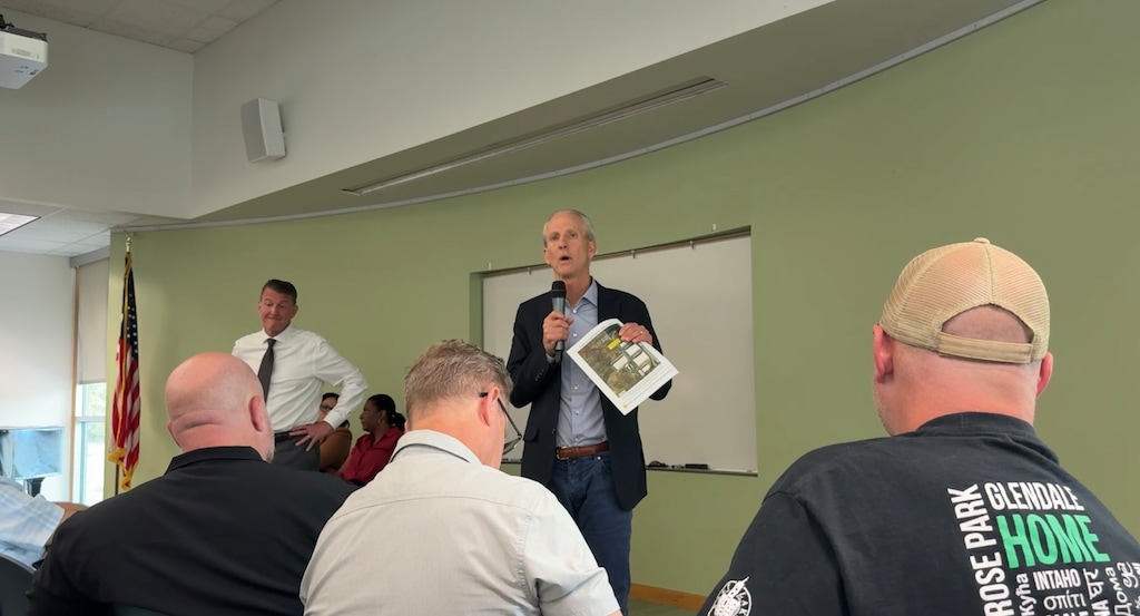 (Jordan Miller | The Salt Lake Tribune) Utah Homeless Services Board Chair Randy Shumway, left, and state homelessness coordinator Wayne Neiderhauser, right, speak to a crowd of over 70 west-side residents about the site of a 1,300-bed homeless campus on Wednesday, Sept. 3, 2025. State officials announced that the campus will be located in Salt Lake City's Northpoint area.