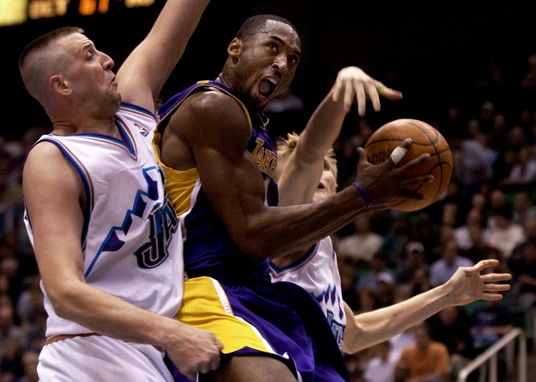 (Trent Nelson  |  The Salt Lake Tribune) Kobe Bryant drives on Greg Ostertag and Andre Kirilenko. Utah Jazz vs. Los Angeles Lakers. 12.04.2002, 7:28:24 PM