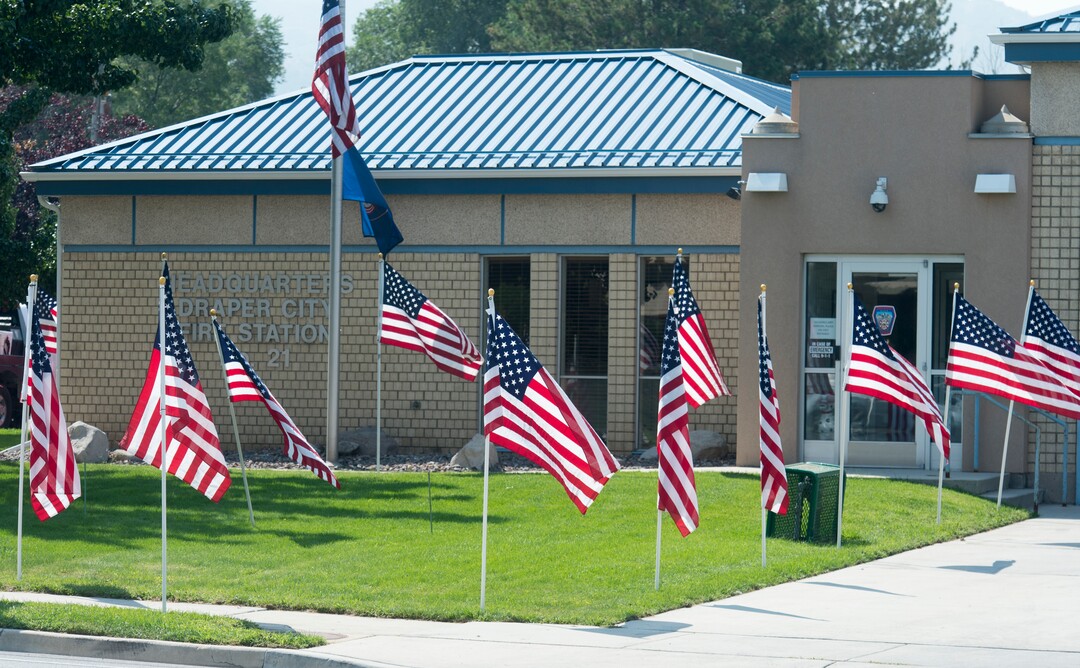 (Rick Egan  |  The Salt Lake Tribune)      American flags fly at the Draper Fire Station in memory of Draper firefighter Matt Burchett, 42, who died fighting wildfires in California. Tuesday, Aug. 14, 2018.
