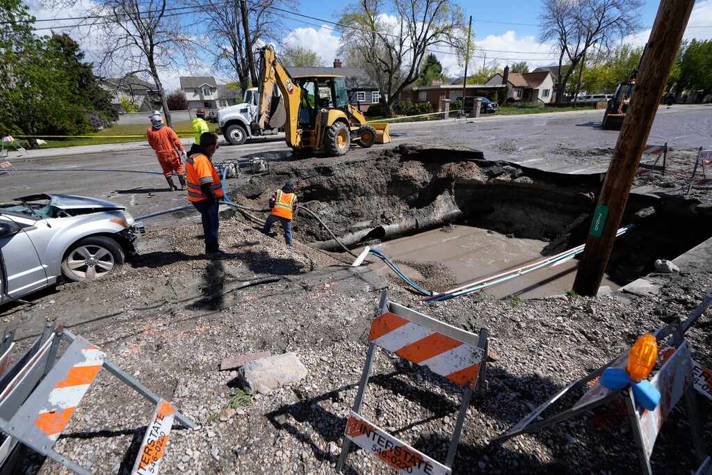 (Francisco Kjolseth | The Salt Lake Tribune) Crews work to repair a water main break that created a large sinkhole that swallowed a parked car near 765 W. 1300 South in Salt Lake City on Tuesday, May 3, 2022.