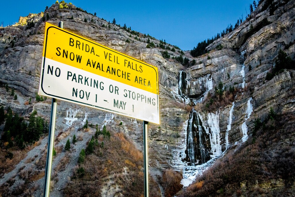 (Isaac Hale | The Daily Herald file photo via AP) Water cascades down Bridal Veil Falls in Provo Canyon, Utah, Dec. 1, 2020. A developer who wanted to buy part of the property and build a high-end treatment lodge at the top and a tram has dropped his lawsuit against Utah County for blocking his plans.