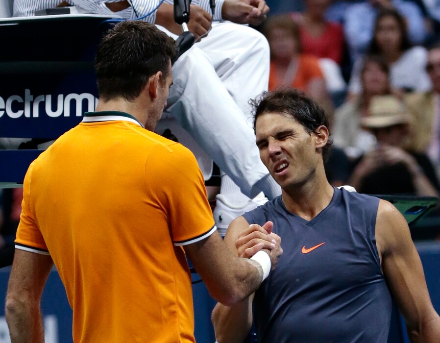 Juan Martin del Potro, of Argentina, shakes hands with Rafael Nadal, of Spain, after Nadal retired from a match during the semifinals of the U.S. Open tennis tournament, Friday, Sept. 7, 2018, in New York. (AP Photo/Andres Kudacki)