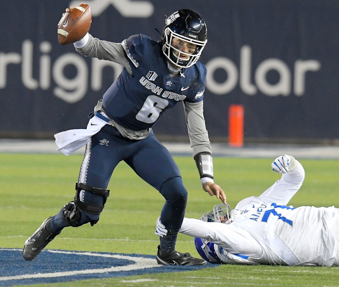 Utah State quarterback Andrew Peasley (6) scrambles away from Air Force defensive tackle George Silvanic (78) during the first half of an NCAA college football game Thursday, Dec. 3, 2020, in Logan, Utah. (Eli Lucero/The Herald Journal via AP, Pool)