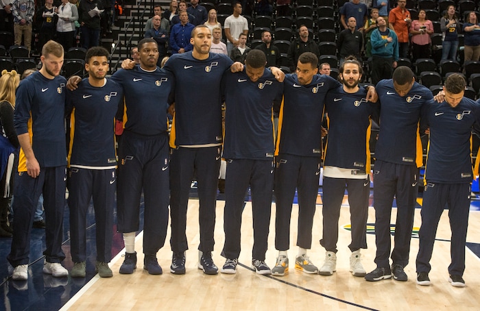 (Rick Egan  |  The Salt Lake Tribune) The Utah Jazz stand together arm in arm, during the national anthem, in preseason basketball  action, Utah Jazz vs. Sydney Kings, in Salt Lake City, Sunday, October 2, 2017.


