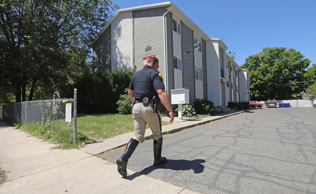 A police officer walks to a building where a man was taken into custody in connection with missing University of Utah student MacKenzie Lueck Friday, June 28, 2019, in Salt Lake City. Authorities are filing murder and kidnapping charges in the death of a Utah college student who disappeared 11 days ago. Salt Lake City police chief Mike Brown said 31-year-old Ayoola A. Ajayi will be charged with aggravated murder, kidnaping and desecration of a body in the death of 23-year-old Mackenzie Lueck. (AP Photo/Rick Bowmer)