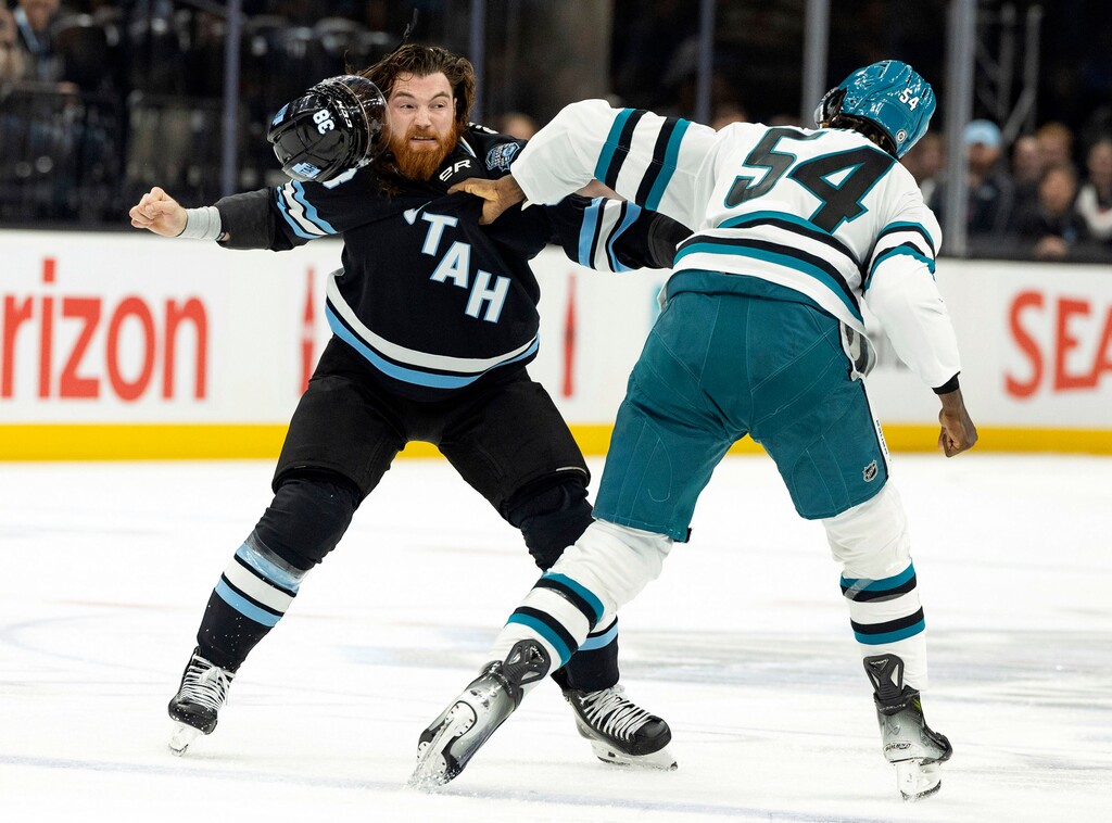San Jose Sharks right wing Givani Smith (54) fights against Utah Hockey Club center Liam O'Brien, left, during the first period of an NHL hockey game, Monday, Oct 28, 2024, in Salt Lake City. (AP Photo/Melissa Majchrzak)