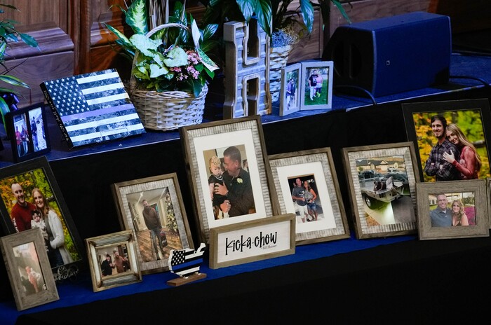(Francisco Kjolseth  |  The Salt Lake Tribune) Family photographs during funeral services for Santaquin police Sgt. Bill Hooser at the UCCU Center at Utah Valley University on Monday, May 13, 2024.