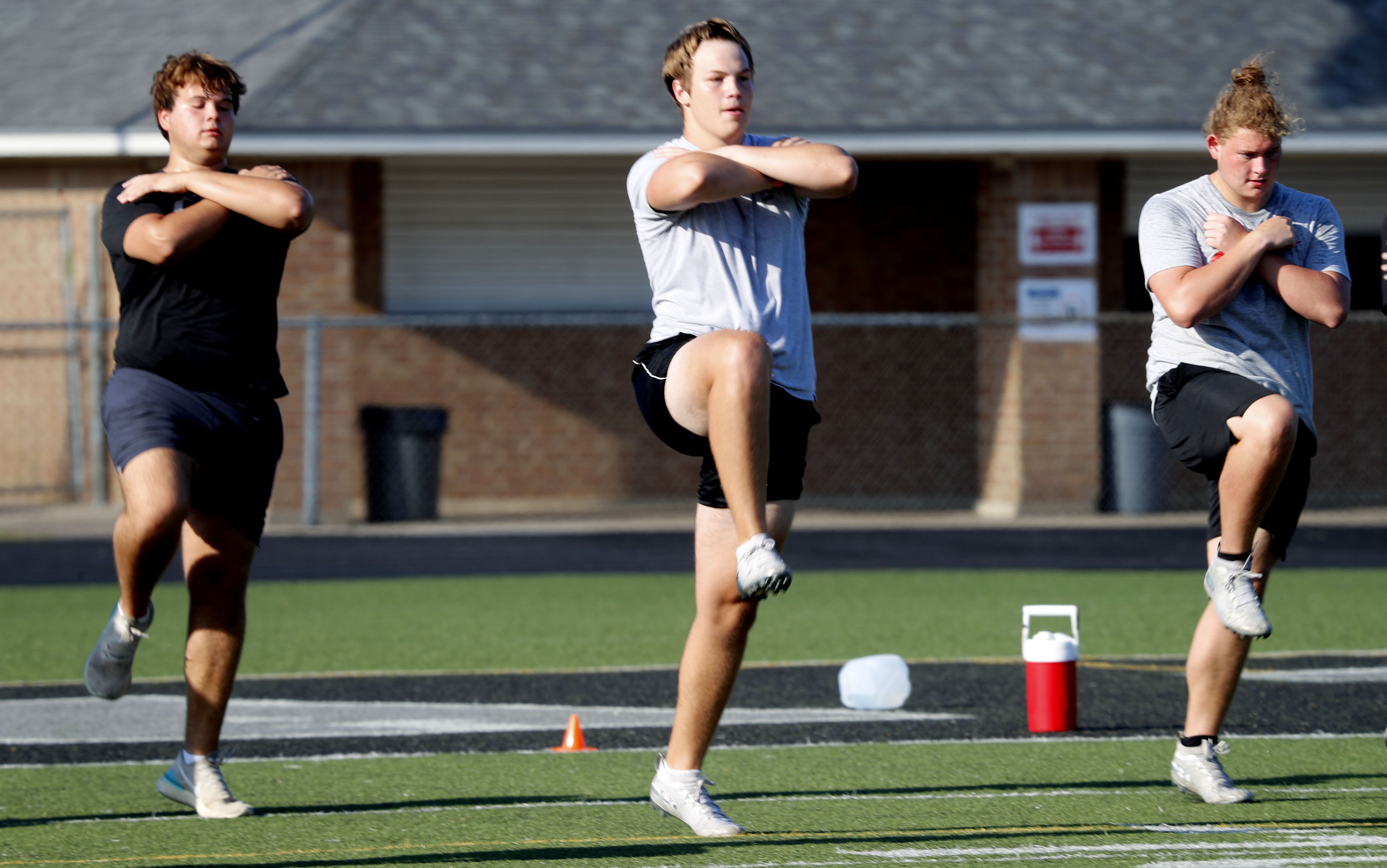 (LM Otero | AP file photo)  With social distancing in mind, student athletes run a drill during the reopening of a strength and conditioning camp at Arlington Martin High School Thursday, June 18, 2020, in in Arlington, Texas.