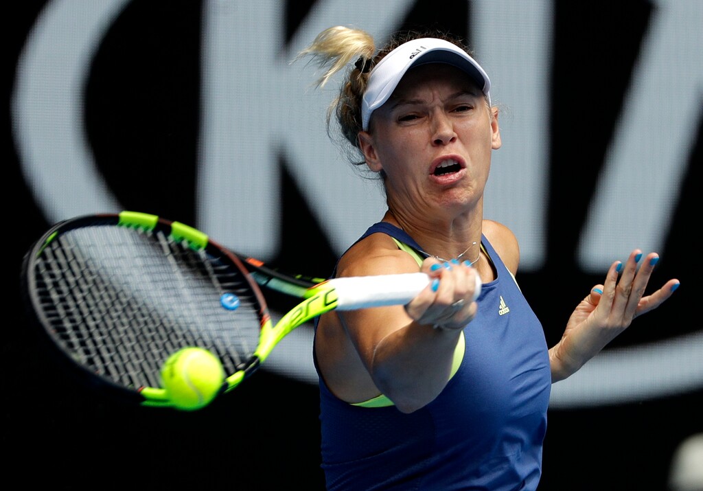 Denmark's Caroline Wozniacki hits a forehand return to Slovakia's Magdalena Rybarikova during their fourth round match at the Australian Open tennis championships in Melbourne, Australia Sunday, Jan. 21, 2018. (AP Photo/Dita Alangkara)