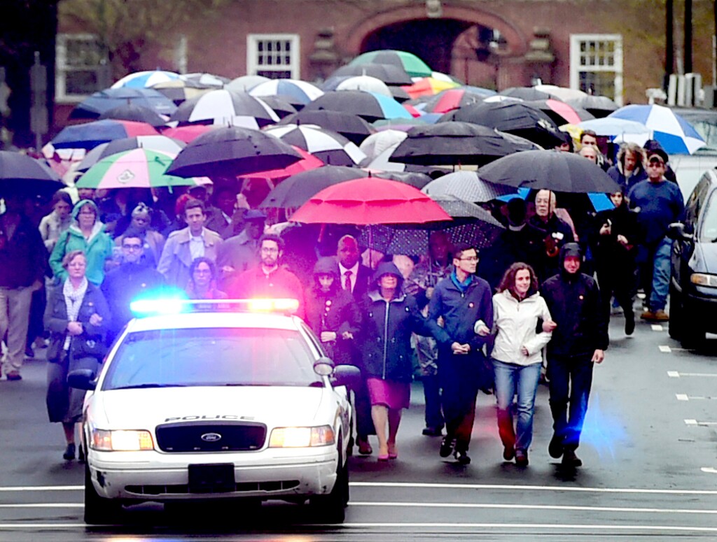 In this Tuesday, April 25, 2017 photo, Yale University graduate assistants, belonging to Local 33 Unite Here International Union, and their supporters march up Hillhouse Ave. in New Haven, Conn., towards Yale President Peter Salovey's House, during a demonstration calling for the university to start negotiating a contract with the Local 33 union. (Peter Hvizdak/New Haven Register via AP)