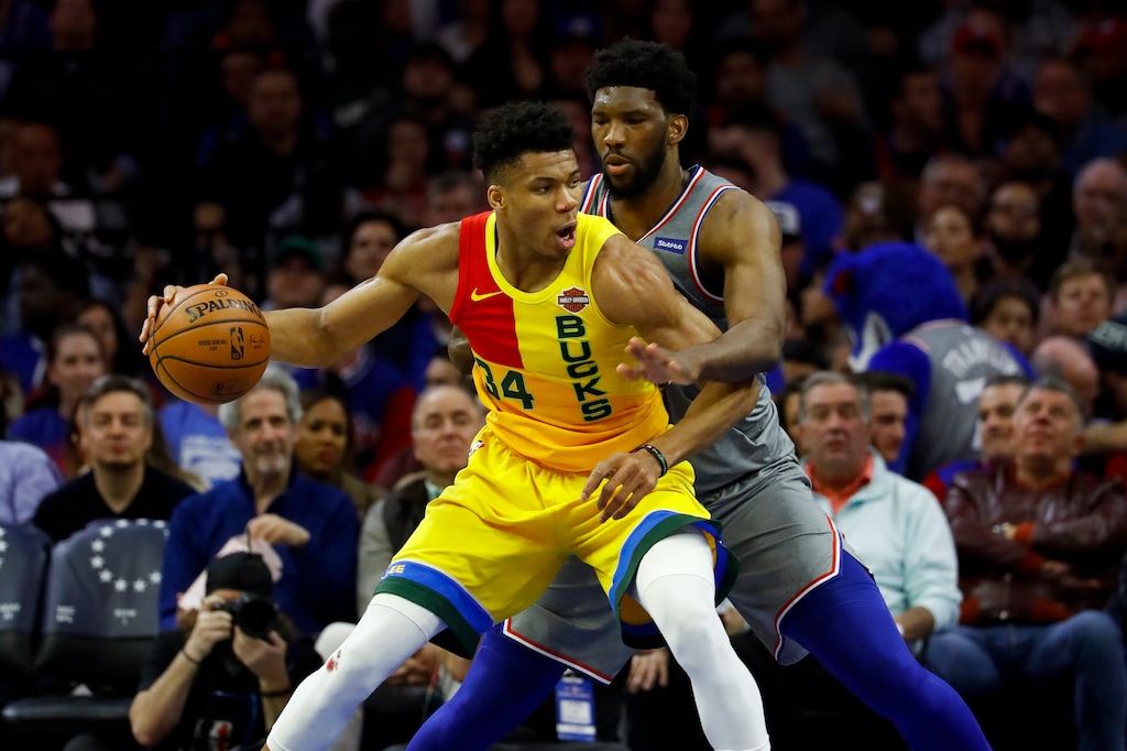 Milwaukee Bucks' Giannis Antetokounmpo, left, tries to drive past Philadelphia 76ers' Joel Embiid during the first half of an NBA basketball game, Thursday, April 4, 2019, in Philadelphia. (AP Photo/Matt Slocum)
