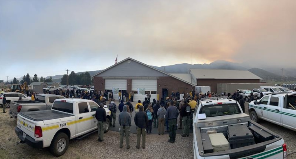 (U.S. Forest Service) As smoke amasses in the background, crews gather at the Pine Valley fire station on Sunday, June 22, 2025, for information about the Forsyth Fire that has burned more than 1,600 acres since Thursday.