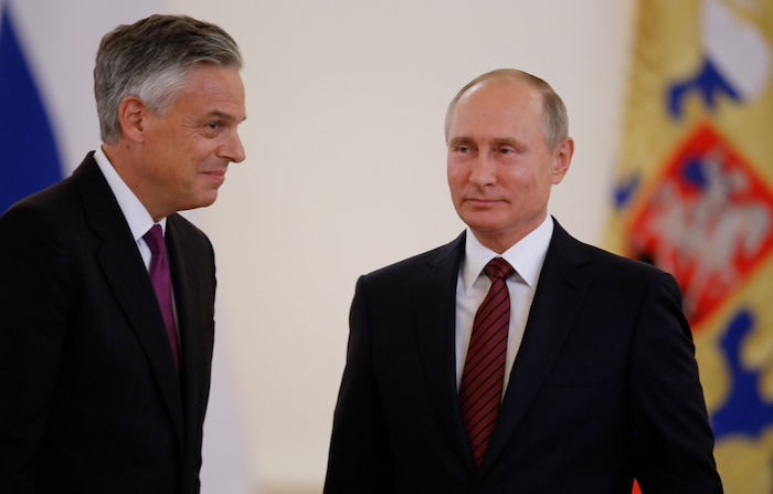 U.S. Ambassador Jon Huntsman, left, walks after presenting credentials to Russian President Vladimir Putin, right, during a ceremony in the Kremlin in Moscow, Russia, on Tuesday, Oct. 3, 2017. The new U.S. Ambassador to Russia presented his credentials to President Vladimir Putin in the Kremlin on Monday amid investigations into Moscow's meddling in the 2016 U.S. elections. (AP Photo/Pavel Golovkin, Pool)