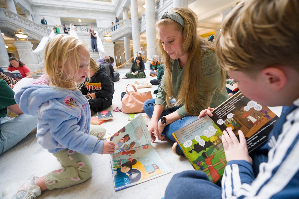 (Bethany Baker  |  The Salt Lake Tribune) Arianne Hellewell, center, helps her daughter Lily Hellewell, 3, read as her son Hyrum Hellewell, 9, also reads as Let Utah Read hosts its annual read-in at the Utah Capitol Rotunda in Salt Lake City on Friday, Feb. 13, 2026.