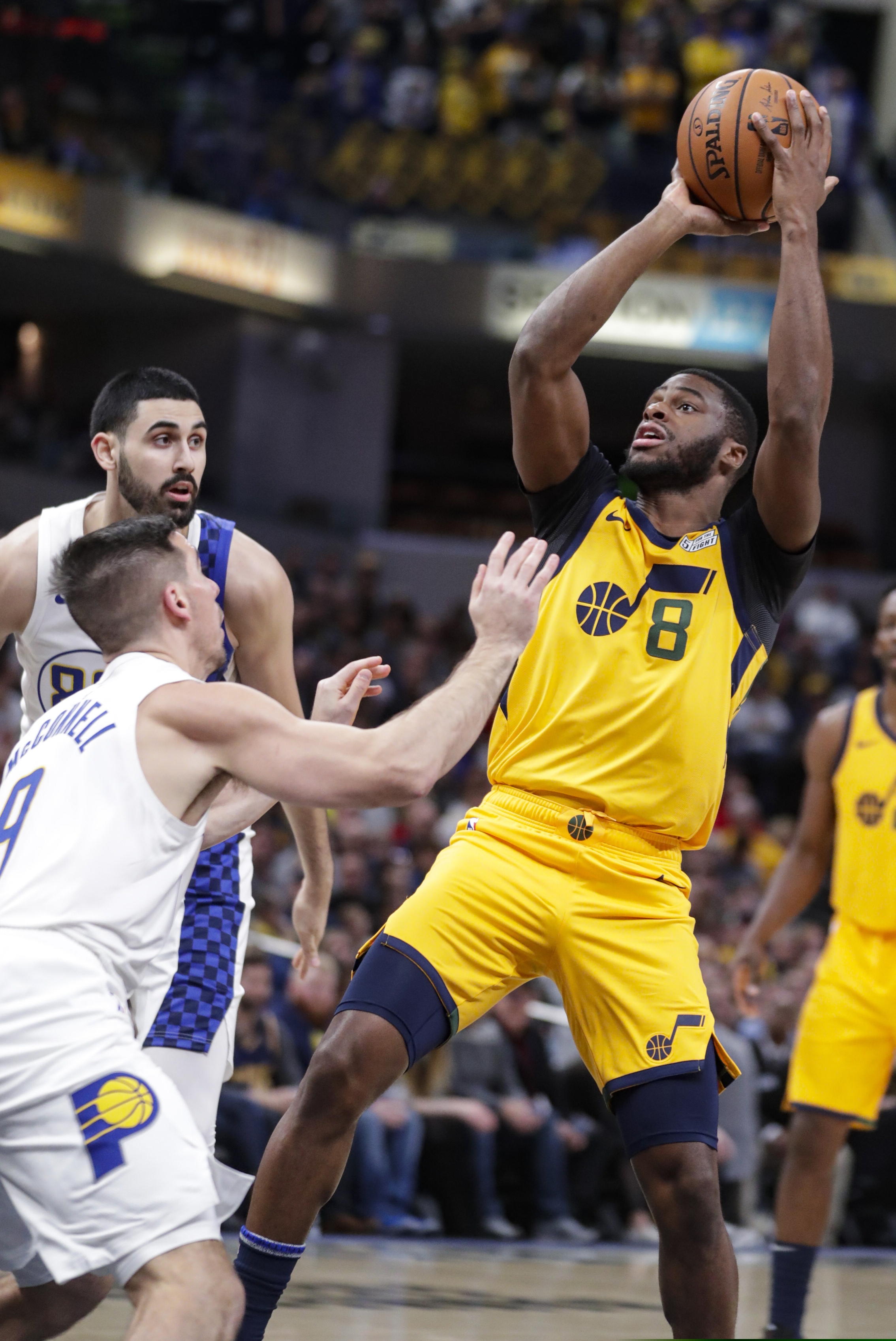 Utah Jazz guard Emmanuel Mudiay (8) shoots over Indiana Pacers guard T.J. McConnell (9) during the second half of an NBA basketball game in Indianapolis, Wednesday, Nov. 27, 2019. The Pacers won 121-102. (AP Photo/Michael Conroy)