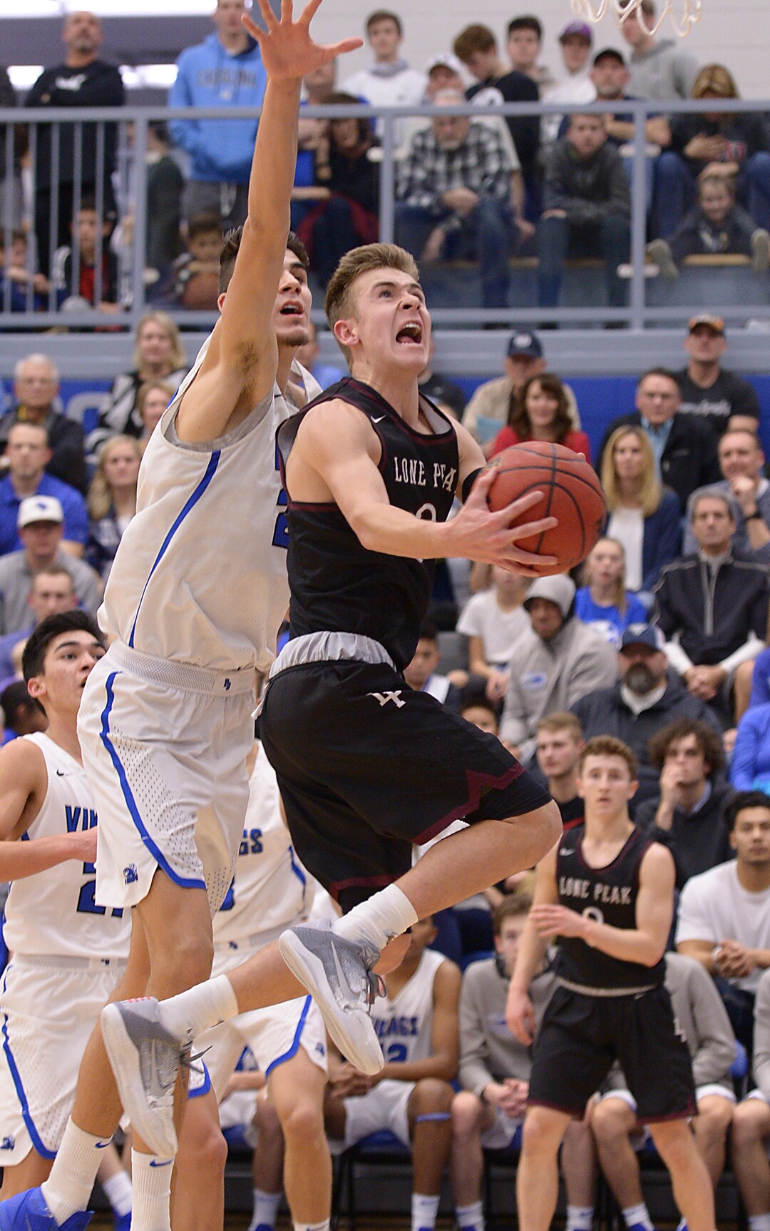 (Leah Hogsten  |  The Salt Lake Tribune) Lone Peak's Steven Ashworth skies to the net around Pleasant Grove's .  Matt Van Komen. High School boys' basketball team leads Lone Peak High School 26-20 during their game Friday, January 26, 2018 in Pleasant Grove. 