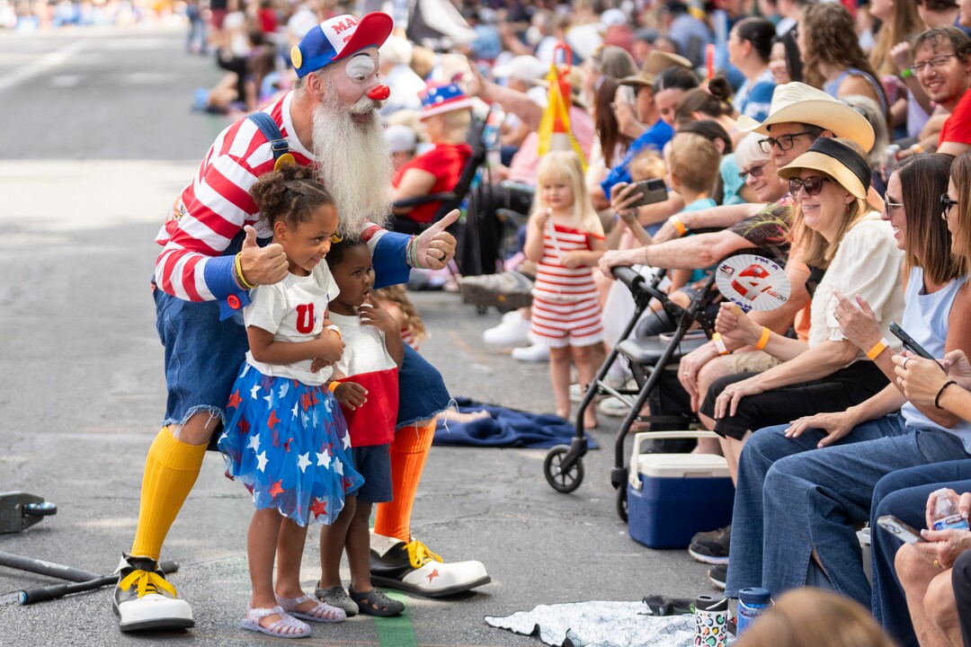 (Rick Egan | The Salt Lake Tribune) Mr. Zach the clown poses for a photo with Maddy and Kingston at the Days of '47 Parade in Salt Lake City on Thursday, July 24, 2025.