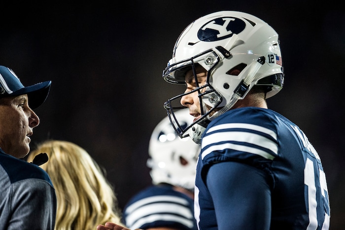 (Chris Detrick  |  The Salt Lake Tribune)  Brigham Young Cougars quarterback Tanner Mangum (12) talks with 
Offensive Coordinator and Quarterbacks Coach Ty Detmer during the game LaVell Edwards Stadium Friday, October 6, 2017. 