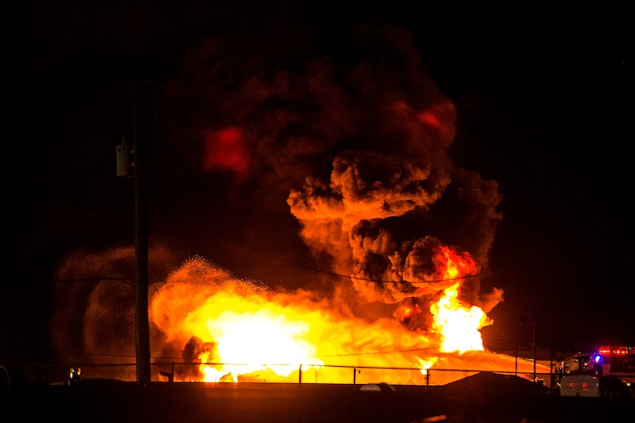 (Chris Detrick  |  The Salt Lake Tribune)  Firefighters attempt to put out a burning semitrailer that was hauling thousands of gallons of fuel on Interstate-15 in Midvale Thursday, January 18, 2018.   Lt. Todd Royce of the Utah Highway Patrol said the truck was southbound on the interstate at 7500 South at 7:20 p.m. when a tire caught fire, sending flames toward the tanks.