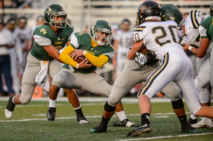 (Trent Nelson | The Salt Lake Tribune) Kearns' Sese Felila runs the ball as Kearns hosts Lone Peak, high school football, Thursday September 14, 2017.