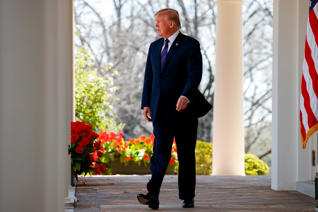 (Evan Vucci | The Associated Press) President Donald Trump arrives to speak during an event on tax policy in the Rose Garden of the White House, Thursday, April 12, 2018, in Washington. The owner of the National Enquirer paid $30,000 in late 2015 to a onetime Trump Tower doorman who was offering an embarrassing story about then-presidential candidate Donald Trump, but the tabloid never published it, according to a person familiar with the payment.