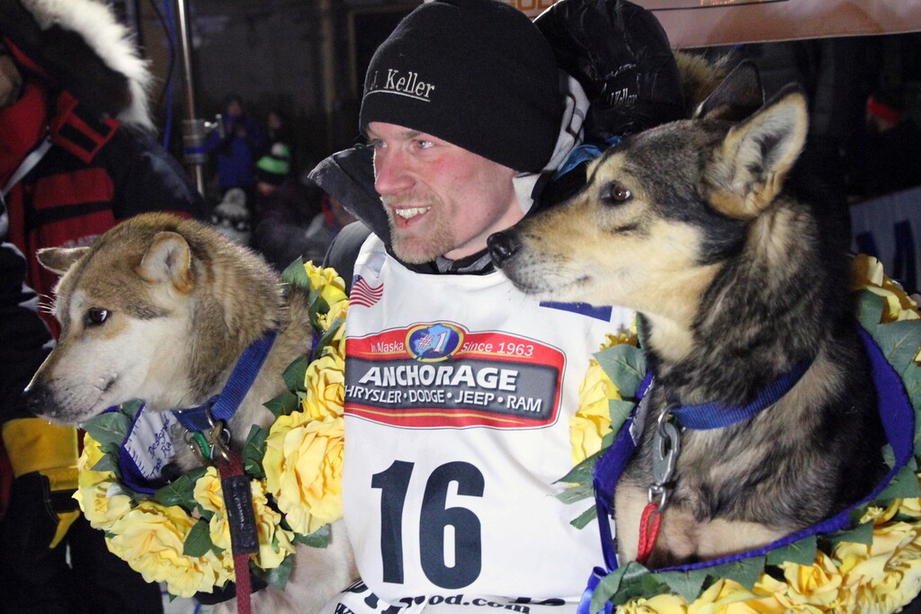 FILE - In this March 15, 2016, file photo, Dallas Seavey poses with his lead dogs Reef, left, and Tide after finishing the Iditarod Trail Sled Dog Race in Nome, Alaska. Seavey won his third straight Iditarod, for his fourth overall title in the last five years. Four-time Iditarod champion Dallas Seavey denies he administered banned drugs to his dogs in this year's race, and has withdrawn from the 2018 race in protest. The Iditarod Trail Committee on Monday identified Seavey as the musher who had four dogs test positive for a banned opioid pain reliever after finishing the race last March in Nome. (AP Photo/Mark Thiessen, File)