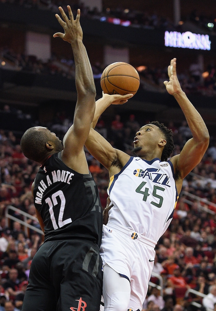 Utah Jazz guard Donovan Mitchell (45) shoots as Houston Rockets forward Luc Mbah a Moute (12) defends during the second half in Game 5 of an NBA basketball second-round playoff series, Tuesday, May 8, 2018, in Houston. (AP Photo/Eric Christian Smith)