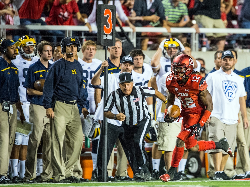 (Chris Detrick | The Salt Lake Tribune file photo) Michigan Wolverines head coach Jim Harbaugh watches as Utah Utes defensive back Justin Thomas (12) runs for a touchdown at Rice-Eccles Stadium Thursday September 3, 2015. Thomas ran for 55 yards for a game-clinching touchdown in the fourth quarter after intercepting a pass from Michigan Wolverines quarterback Jake Rudock. Utah defeated Michigan 24-17.
