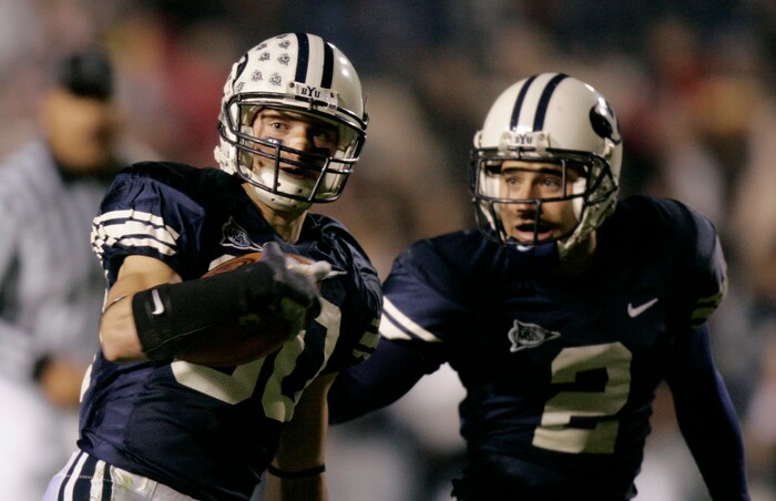 Brigham Young wide receiver McKay Jacobson (80) takes the ball 77 yards on a punt-return for a touchdown against Wyoming as wide receiver Bryce Mahuika (2) watches during the fourth quarter of their college football game Thursday, Nov. 9, 2006, in Provo, Utah. BYU beat Wyoming, 55-7. (AP Photo/Douglas C. Pizac)