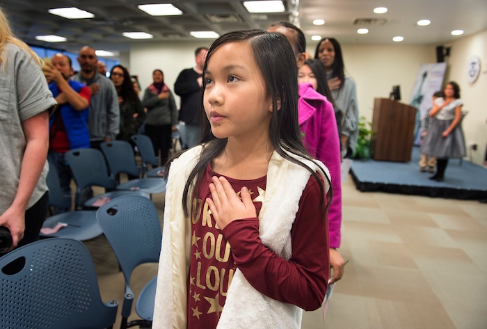(Scott Sommerdorf   |  The Salt Lake Tribune)   Children recite the pledge of allegiance during a ceremony in recognition of children who have obtained citizenship through their parents, Thursday, December 28, 2017. Some were adopted by U.S. citizen parents; others derived citizenship when their immigrant parents became naturalized citizens.