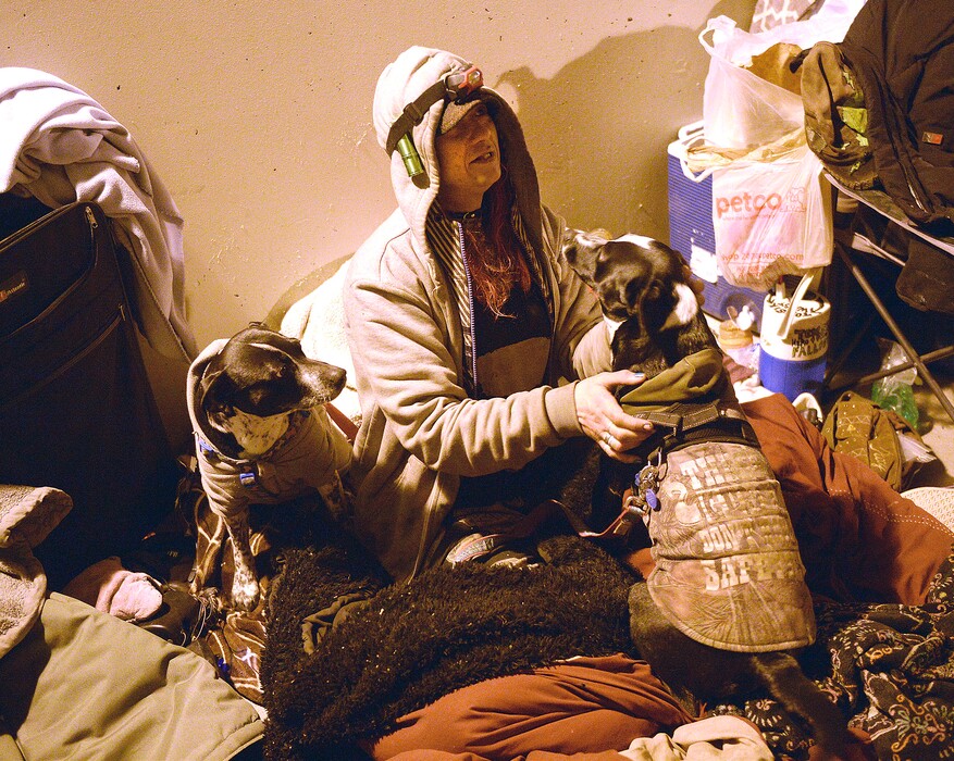 (Al Hartmann | The Salt Lake Tribune) A homeless woman called Thumper is interviewed while cuddled in her bedroll with her dogs Hope and Despair. Volunteers were counting homeless people in Salt Lake City for the annual Point In Time survey at 4:30 a.m. Thursday, Jan. 25, 2018. "Thumper" had spent the night with a couple friends, camped in the tunnel between Sugar House Park and Hidden Hollow.